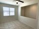 Spacious living room featuring tile floors and a ceiling fan at 42025 W Manderas Ln, Maricopa, AZ 85138