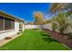 Well-maintained backyard with artificial turf, rock landscaping, and a privacy wall at 4229 E Crest Ct, Gilbert, AZ 85298