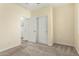 Cozy carpeted bedroom featuring a closet and an entrance to a laundry area at 4229 E Crest Ct, Gilbert, AZ 85298