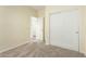 Carpeted bedroom with a closet, neutral walls, and an open entrance to another room at 4229 E Crest Ct, Gilbert, AZ 85298