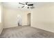 Comfortable carpeted bedroom with ceiling fan, neutral walls, and an en-suite bathroom at 4229 E Crest Ct, Gilbert, AZ 85298