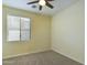 Well-lit bedroom featuring a ceiling fan and window with blinds at 4229 E Crest Ct, Gilbert, AZ 85298