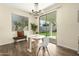 Cozy dining area with modern chandelier, stylish table and chairs, and sliding glass door to the backyard at 4229 E Crest Ct, Gilbert, AZ 85298