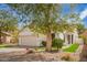 Inviting single-story home with a well-manicured front yard featuring low-maintenance landscaping and beautiful synthetic grass at 4229 E Crest Ct, Gilbert, AZ 85298