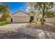 Charming single-story home with a two-car garage and a well-manicured front yard with fresh rock and synthetic grass at 4229 E Crest Ct, Gilbert, AZ 85298