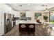 Spacious kitchen featuring white cabinets, stainless steel appliances, a large island with seating, and an adjacent dining area at 4229 E Crest Ct, Gilbert, AZ 85298