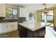 Modern kitchen with white cabinets, island, and view to backyard at 4229 E Crest Ct, Gilbert, AZ 85298