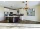 Open kitchen with island, white cabinets, and a chandelier at 4229 E Crest Ct, Gilbert, AZ 85298