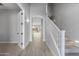 Light-filled entryway with tile floors and staircase at 4257 E John St, Gilbert, AZ 85295