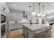 Modern kitchen with white cabinets and granite countertops at 4257 E John St, Gilbert, AZ 85295