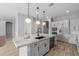 Modern kitchen with white cabinets and granite countertops at 4257 E John St, Gilbert, AZ 85295