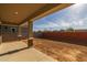 Covered patio with view of backyard and brick wall at 4257 E John St, Gilbert, AZ 85295