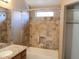 Bathroom features granite vanity, tiled shower/tub combo, and neutral color scheme at 42659 W Sunland Dr, Maricopa, AZ 85138