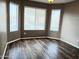 Bedroom with bay window and laminate wood flooring at 42659 W Sunland Dr, Maricopa, AZ 85138