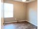 Spacious bedroom with neutral walls, laminate wood flooring, and a ceiling fan at 42659 W Sunland Dr, Maricopa, AZ 85138