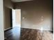 Bright bedroom with laminate wood flooring and neutral walls at 42659 W Sunland Dr, Maricopa, AZ 85138