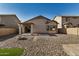 Backyard with gravel, fire pit, and covered patio at 42788 W Martie Lynn Rd, Maricopa, AZ 85138