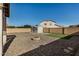 Backyard with gravel landscaping, fire pit, and storage shed at 42788 W Martie Lynn Rd, Maricopa, AZ 85138