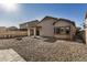 Backyard with gravel, fire pit, and covered patio at 42788 W Martie Lynn Rd, Maricopa, AZ 85138