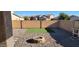 Backyard with fire pit and artificial turf at 42788 W Martie Lynn Rd, Maricopa, AZ 85138