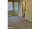 Bright bedroom with neutral carpeting and a large closet at 42788 W Martie Lynn Rd, Maricopa, AZ 85138