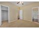 Bedroom with ceiling fan and access to bathroom and closet at 42788 W Martie Lynn Rd, Maricopa, AZ 85138