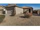 Tan house with tile roof, two-car garage, and desert landscaping at 42788 W Martie Lynn Rd, Maricopa, AZ 85138