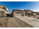 Tan house with tile roof, two-car garage, and desert landscaping at 42788 W Martie Lynn Rd, Maricopa, AZ 85138