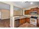 Stainless steel appliances and light wood cabinets in kitchen at 42788 W Martie Lynn Rd, Maricopa, AZ 85138