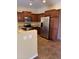 Modern kitchen with stainless steel appliances and tile flooring at 42788 W Martie Lynn Rd, Maricopa, AZ 85138