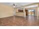 Open concept living room with kitchen view and tile floors at 42788 W Martie Lynn Rd, Maricopa, AZ 85138