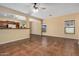 Open concept living room with kitchen view and tile floors at 42788 W Martie Lynn Rd, Maricopa, AZ 85138