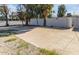 Large backyard with a cracked concrete slab and a white fence at 4346 E Earll Dr, Phoenix, AZ 85018