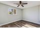 Bright bedroom with wood-look floors and ceiling fan at 4346 E Earll Dr, Phoenix, AZ 85018