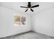 Bright bedroom with grey carpet, ceiling fan and window at 4607 E Park St, Phoenix, AZ 85042