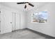 Spacious bedroom with grey carpet, ceiling fan and window at 4607 E Park St, Phoenix, AZ 85042