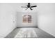 Bright bedroom with grey carpet, ceiling fan and backyard view at 4607 E Park St, Phoenix, AZ 85042