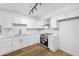 Modern white kitchen with stainless steel appliances and white shaker cabinets at 4607 E Park St, Phoenix, AZ 85042