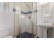 Bathroom with pedestal sink, shower and blue tile accents at 4728 E Mulberry Dr, Phoenix, AZ 85018