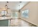 Dining area with wood-look floors and modern light fixtures at 4737 N 9Th St, Phoenix, AZ 85014