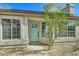 Front view of a charming house with a teal door and large windows at 4737 N 9Th St, Phoenix, AZ 85014