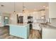 Bright kitchen with white cabinets, granite countertops, and a teal island at 4737 N 9Th St, Phoenix, AZ 85014