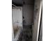 This bathroom, with a weathered tub and damaged walls, needs extensive renovation and repair at 504 W Baseline Rd, Buckeye, AZ 85326
