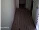 This hallway features damaged flooring and weathered walls, indicating it needs significant repair and renovation at 504 W Baseline Rd, Buckeye, AZ 85326