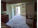 This kitchen space, in need of renovation, connects to the outdoors through an open doorway at 504 W Baseline Rd, Buckeye, AZ 85326