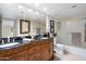 Elegant bathroom with ornate wood vanity and granite countertops at 5136 N 31St Pl # 614, Phoenix, AZ 85016