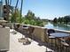 Seating area overlooks a lake with wicker chairs and tables at 5136 N 31St Pl # 614, Phoenix, AZ 85016