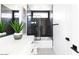 Modern bathroom with black and white tile and a freestanding tub at 5918 E Tina Dr, Phoenix, AZ 85054