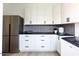 Modern kitchen with white cabinets, stainless steel appliances, and gray tile backsplash at 5918 E Tina Dr, Phoenix, AZ 85054