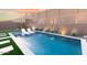 Relaxing rectangular pool with artificial turf and floating chairs at 5918 E Tina Dr, Phoenix, AZ 85054